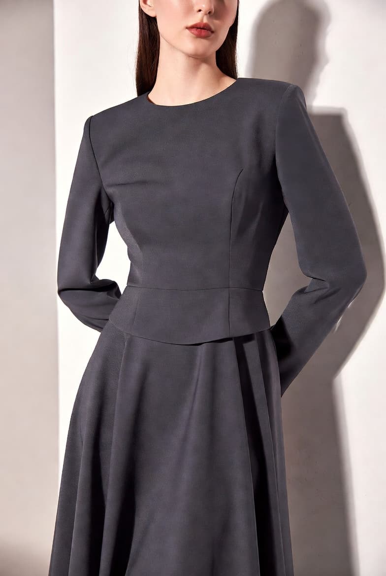 Sculpted charcoal skirt silhouette from the ORÉVIA edit