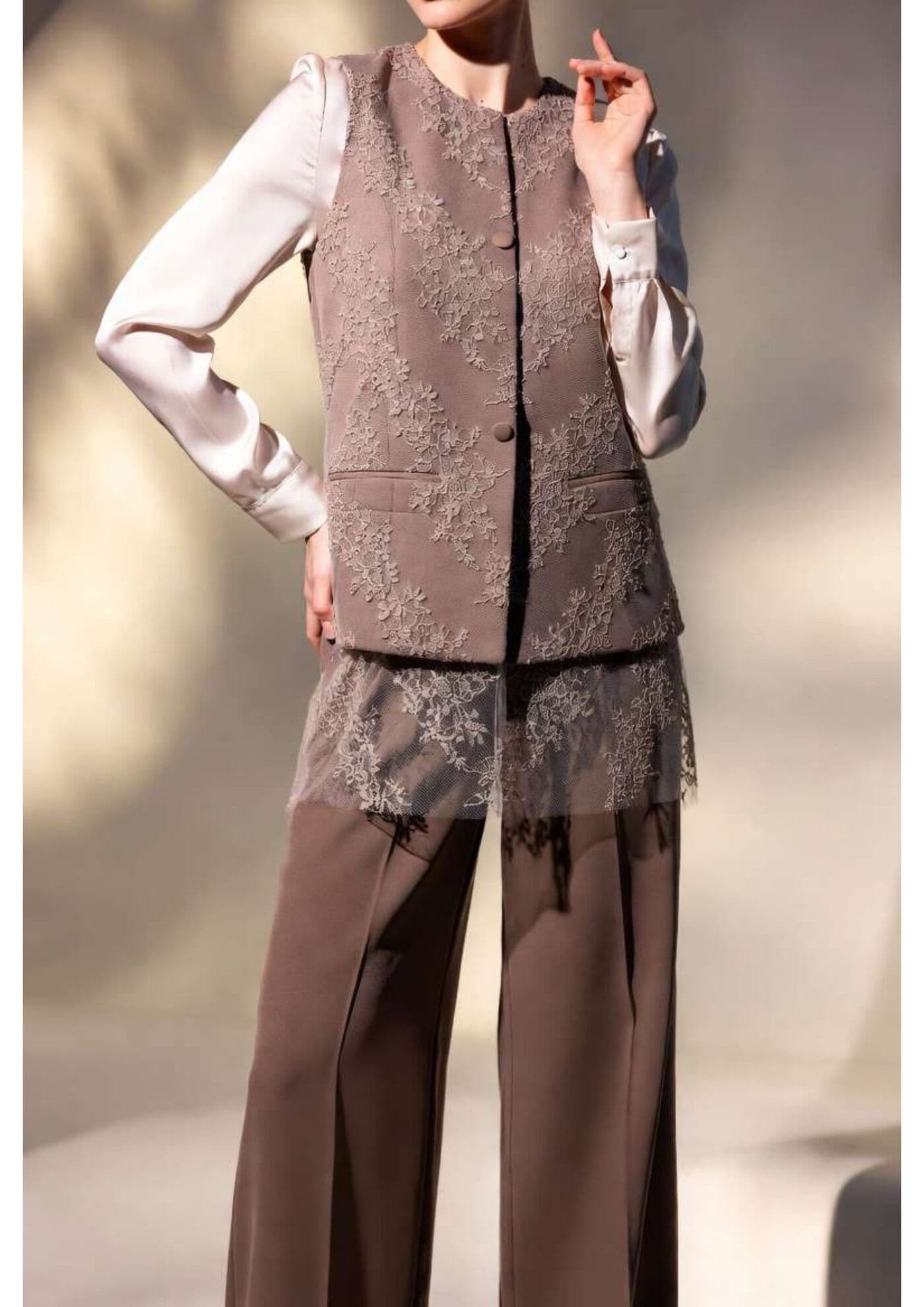 Wide-leg taupe trousers styled with layered tailoring